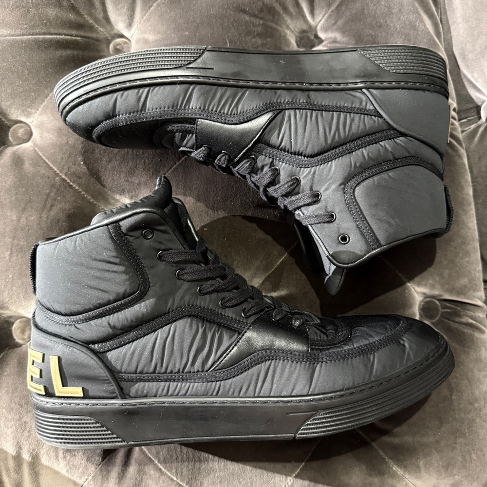CHANEL Black High-Top Sneakers with Gold CC Accent